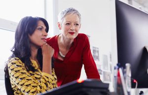 Two women looking at a monitor